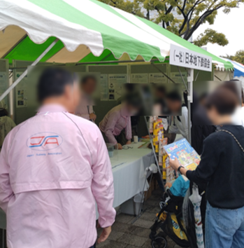 写真：リーフレットを手に取る来訪者の方々